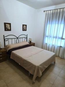 a bedroom with two beds and a large window at Maestrat13 in Peñíscola