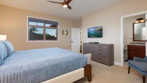 1 dormitorio con 1 cama azul, vestidor y ventana en SWEET HEAVEN Upscale 4BR KaMilo Home with Bikes and Golf Clubs, en Waikoloa 44 fotos más
