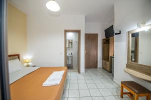 a bedroom with a bed and a television in it at Panorama in Elafonisi