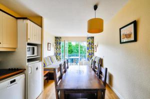 a kitchen and dining room with a table and chairs at Résidence Les Belles Rives - maeva Home - Appartement 3 pièces 7 personnes - Confort MAE-5454 in Argentat