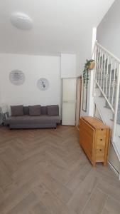 a living room with a couch and a staircase at Nicaredda in Catania