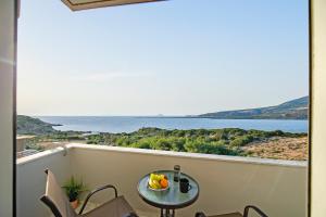a table on a balcony with a view of the water at Panorama in Elafonisi