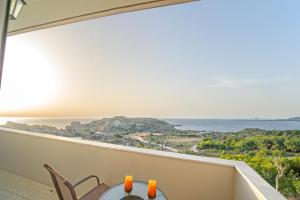 a balcony with a table and chairs and a view of the ocean at Panorama in Elafonisi