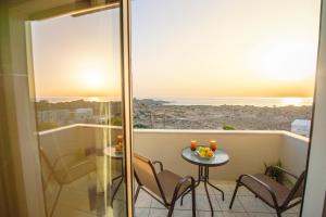 a balcony with a table and chairs and a view of the ocean at Panorama in Elafonisi