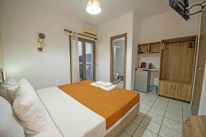 a bedroom with a bed and a kitchen at Panorama in Elafonisi