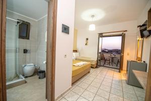 a bathroom with a toilet and a sink and a shower at Panorama in Elafonisi