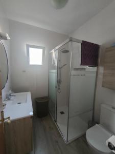 a bathroom with a shower and a toilet and a sink at Villa Coral in Chiclana de la Frontera +20 photos