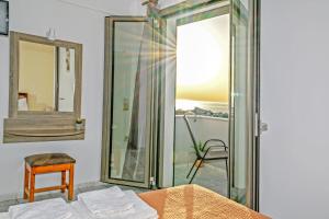 a bedroom with a mirror and a bed and a chair at Panorama in Elafonisi