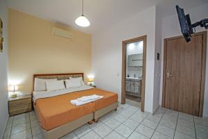 a bedroom with a bed with a robe on it at Panorama in Elafonisi