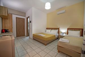 a hotel room with two beds and a refrigerator at Panorama in Elafonisi +37 photos