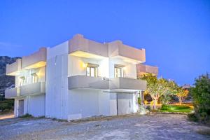 a white building with a lot of windows at Panorama in Elafonisi