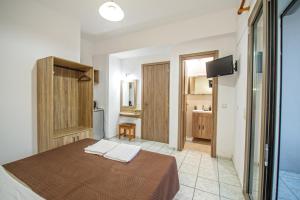 a bedroom with a bed and a bathroom at Panorama in Elafonisi