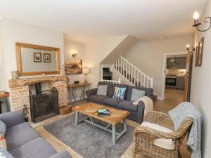 a living room with a couch and a fireplace at Rooftops Cottage in Whitby