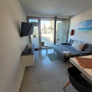 Una sala de estar con un sofá y un televisor. en Gwyneth casa de playa, en Puerto Madryn 33 fotos más