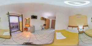 a hotel room with two beds and a mirror at Panorama in Elafonisi