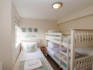 a small room with two bunk beds in it at Rooftops Cottage in Whitby
