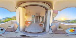 a room with a balcony with chairs and a table at Panorama in Elafonisi