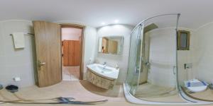 a bathroom with a glass shower and a sink at Panorama in Elafonisi
