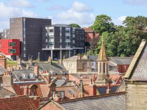 a view of a city with buildings and roofs at Rooftops Cottage in Whitby