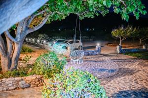 a swing with a car parked in a yard at night at Panorama in Elafonisi