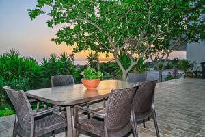 a wooden table and chairs on a patio at Panorama in Elafonisi