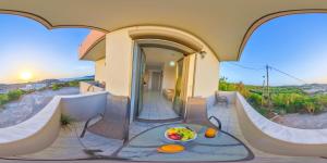 a house with a balcony with a table and a bowl of fruit at Panorama in Elafonisi