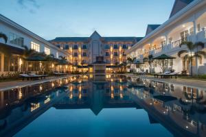 磅同省Glorious Hotel的夜间带水池的酒店庭院