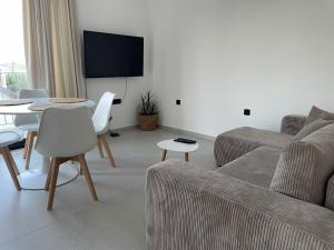 a living room with a couch and a table at Apartmani Natali in Orebić