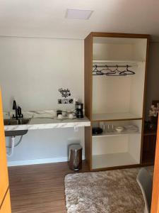a kitchen with a counter and a sink in a room at Microcasa na cobertura in Santa Teresa +5 photos