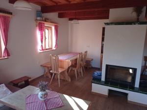 a living room with a table and a fireplace at Chata na Lhotských pasekách in Lhota u Vsetína