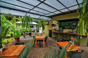 a restaurant with tables and a bar with plants at Fauna Lodge in Drake