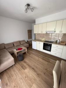 a living room with a couch and a table at Apartmani Pantovic - Apartman 1 in Trebinje