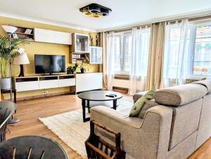 a living room with a couch and a table at Superbe appartement dans le centre de Mons - Arivée autonome in Mons