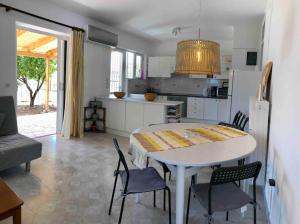 a kitchen and dining room with a table and chairs at Fysis Panorama spectacular view in Porto Rafti