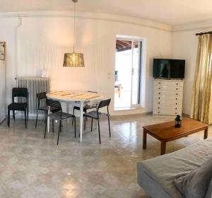 a living room with a table and chairs and a couch at Fysis Panorama spectacular view in Porto Rafti