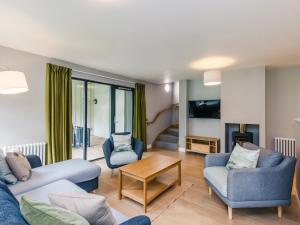 a living room with a couch and chairs and a table at Golden Eagle Lodge in Kingussie