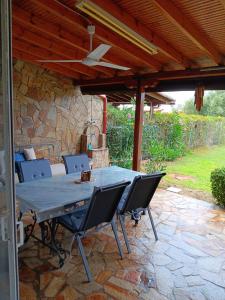 a table and chairs on a stone patio at Sea Breeze Alexandroupolis in Alexandroupoli