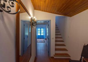 a hallway with stairs leading to a house at Fonte Santa beautiful villa in Santiago do Cacém