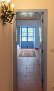 a hallway with a door leading to a room with a door at Fonte Santa beautiful villa in Santiago do Cacém