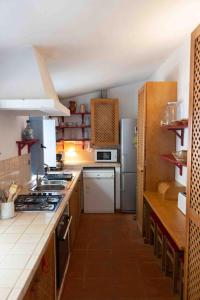 a kitchen with a stove and a refrigerator at Fonte Santa beautiful villa in Santiago do Cacém +53 photos