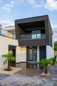 a modern house with black and white at Villa XY in Blagaj