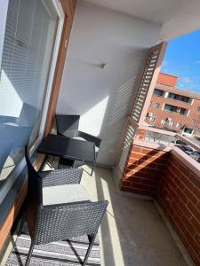 a balcony with two chairs and a staircase on a building at Saunallinen yksiö keskustassa in Pieksamaki