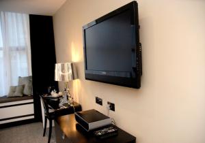 a flat screen tv on the wall of a hotel room at Print Works Hotel in Liverpool