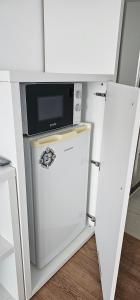 a microwave sitting on top of a refrigerator at Sunset View Blaxy Resort OLIMP by Dany in Olimp