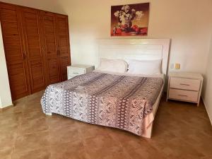 a bedroom with a large bed and two night stands at Luxurious Villa in Sosúa + Pool in Sosúa +8 photos