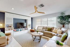 a living room with a couch and a table at Modern Getaway in Cape Coral