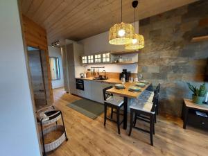 a kitchen with a table and chairs in a room at Apartmán H3 Hrabušice in Hrabušice