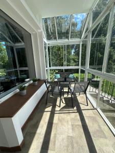 a room with a table and chairs and windows at Pension Moravia in Olomouc