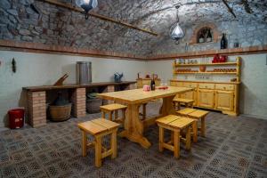 a kitchen with a wooden table and stools in it at B&B da Monsignore in Crespano del Grappa