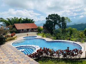 a large swimming pool in front of a house at Finca La Vistosa in Sasaima